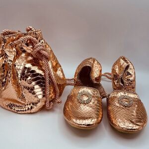 Joan Boyce ballet flats and drawstring bucket bag in rose gold faux leather